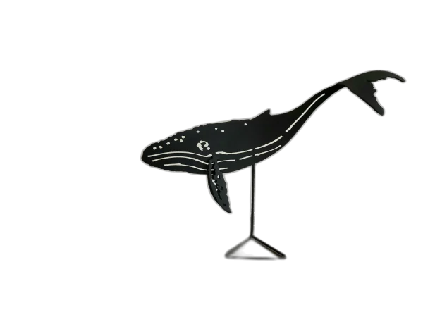 Black-painted steel sculpture of a humpback whale on a stand, featuring detailed cutouts and curves, capturing the whale's distinct silhouette.